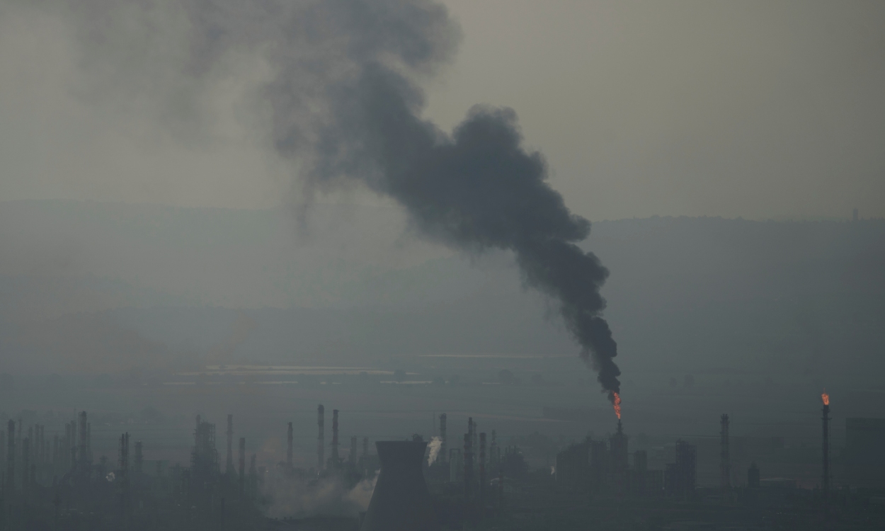 Smoke billows after an Iranian missile struck an oil refinery in Haifa, northern Israel, early Monday, June 16, 2025. (AP Photo/Ariel Schalit)