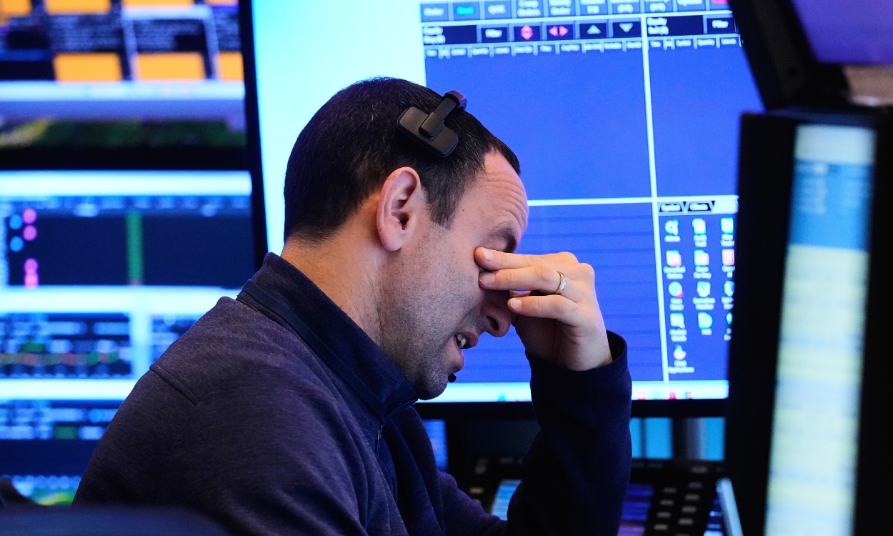 A trader works on the floor of the New York Stock Exchange, Friday, April 25, 2025. (AP Photo/Richard Drew)