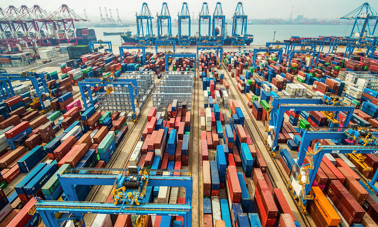 This aerial photo taken on May 14, 2019 shows containers stacked at a port in Qingdao in China's eastern Shandong province. (Photo by STR / AFP) / China OUT